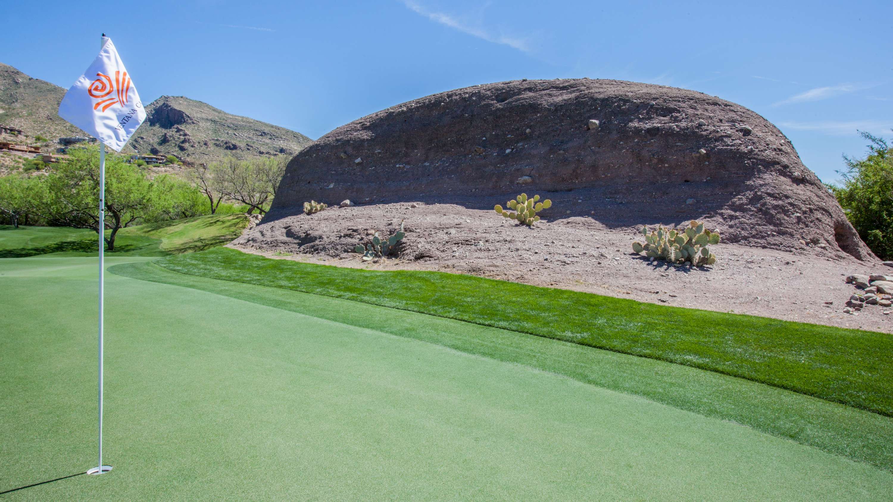 Large rock next to golf green
